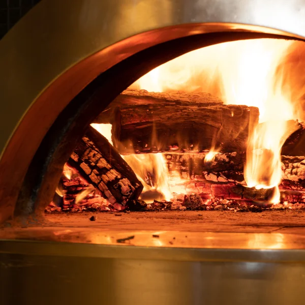 An image showing a sophisticated brand identity, a loyalty program, and coal-fired cooking process.