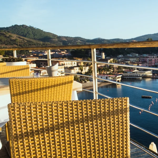 An image showing a restaurant with a marina in the background.